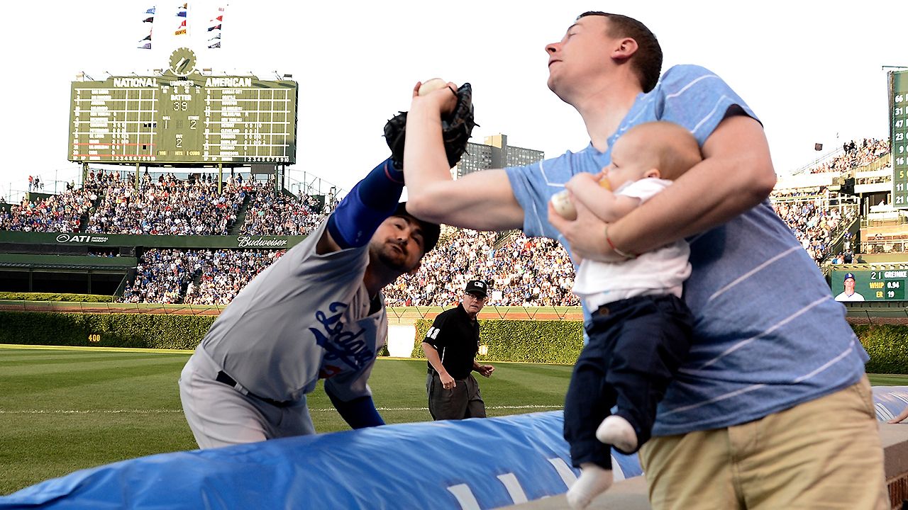 Cubs Fan Makes A Great Catch With a Baby in his Hands!