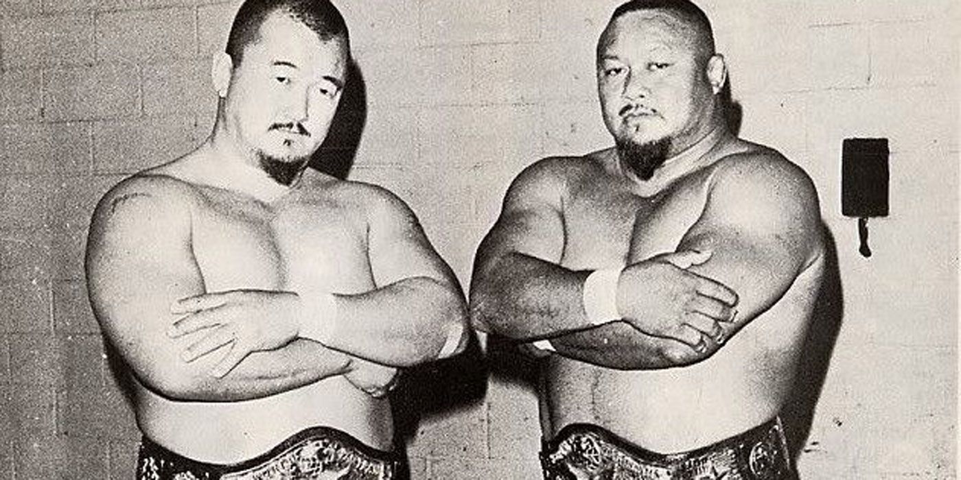 Prof. Tanaka and Mr. Fuji as tag team champions.
