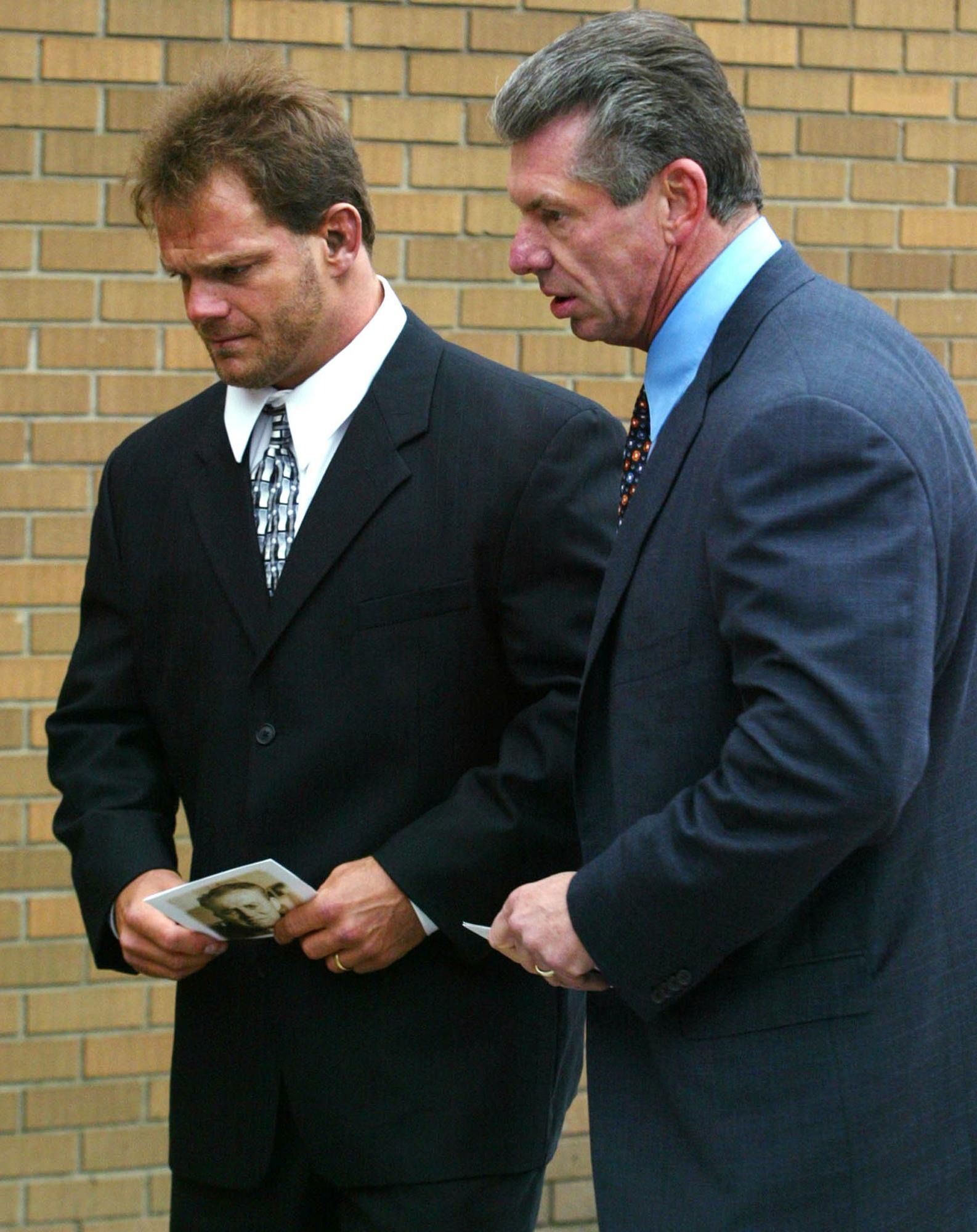 ** FILE ** World Wreslting Entertainment Chairman Vince McMahon, right and wrestler Chris Benoit, from Edmonton, make their way in to a memorial service for wrestling legend Stu Hart Thursday, October 23, 2003. Benoit has been found dead at his suburban Atlanta home along with his wife Nancy and son, World Wrestling Entertainment said Monday June 25, 2007. (AP Photo/Adrian Wyld, CP)