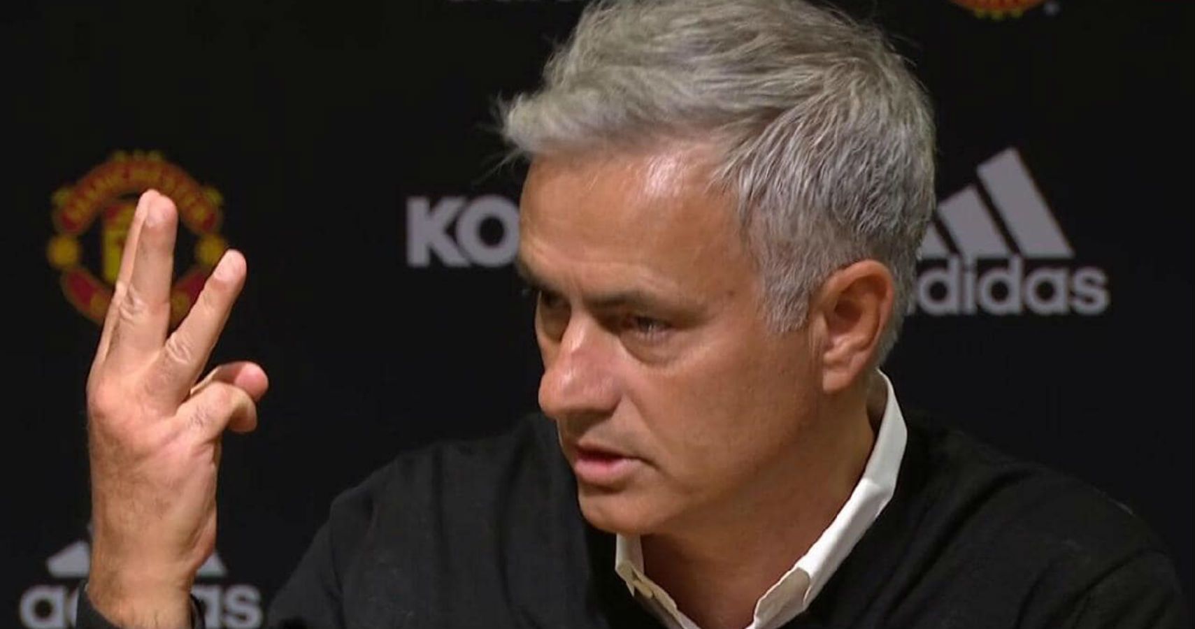  Jose Mourinho is shown talking at a press conference making a three sign with his fingers.