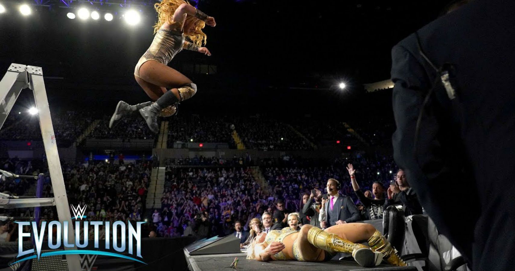 Becky Lynch dives onto charlotte from a ladder