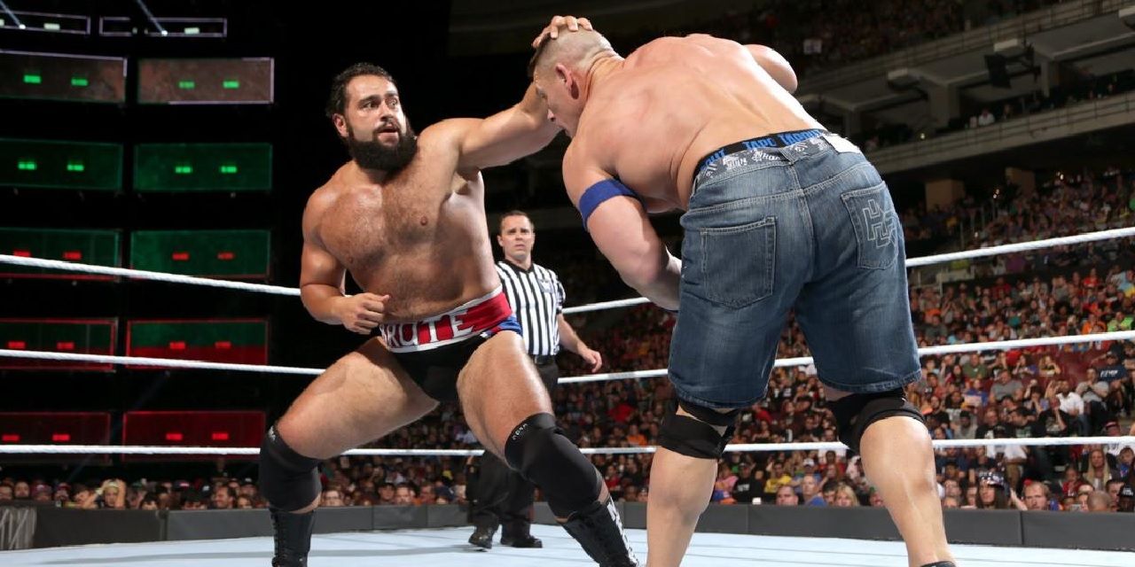 Rusev punching John Cena