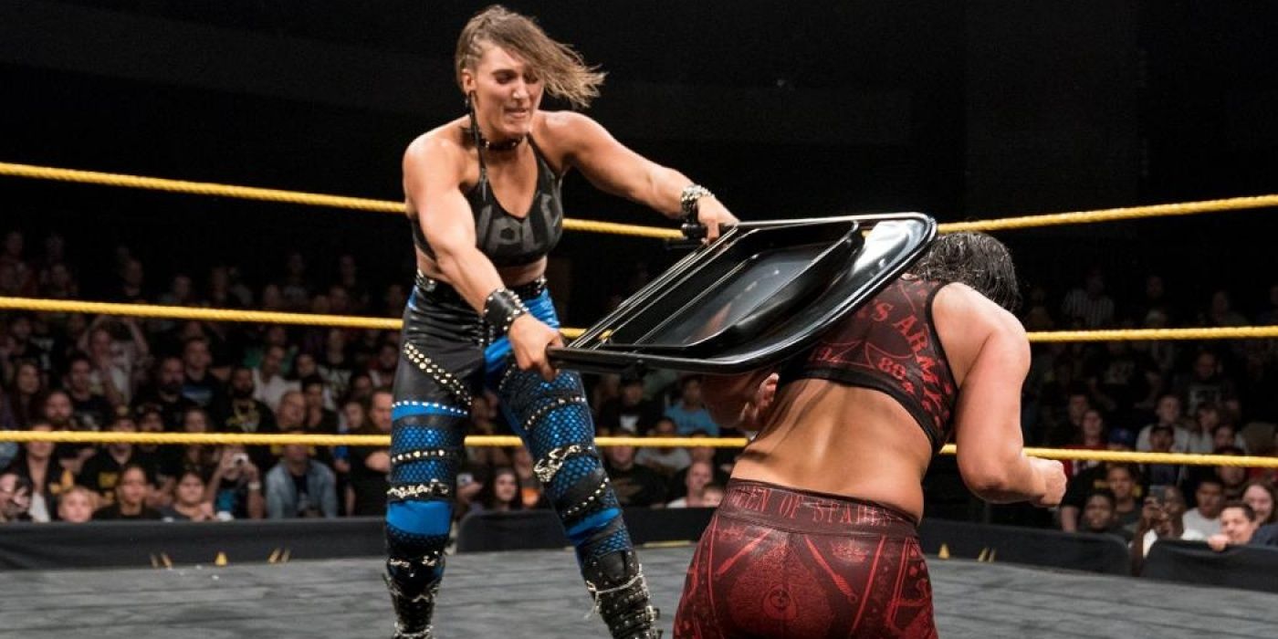 Rhea Ripley hits Shayna Baszler with a steel chair