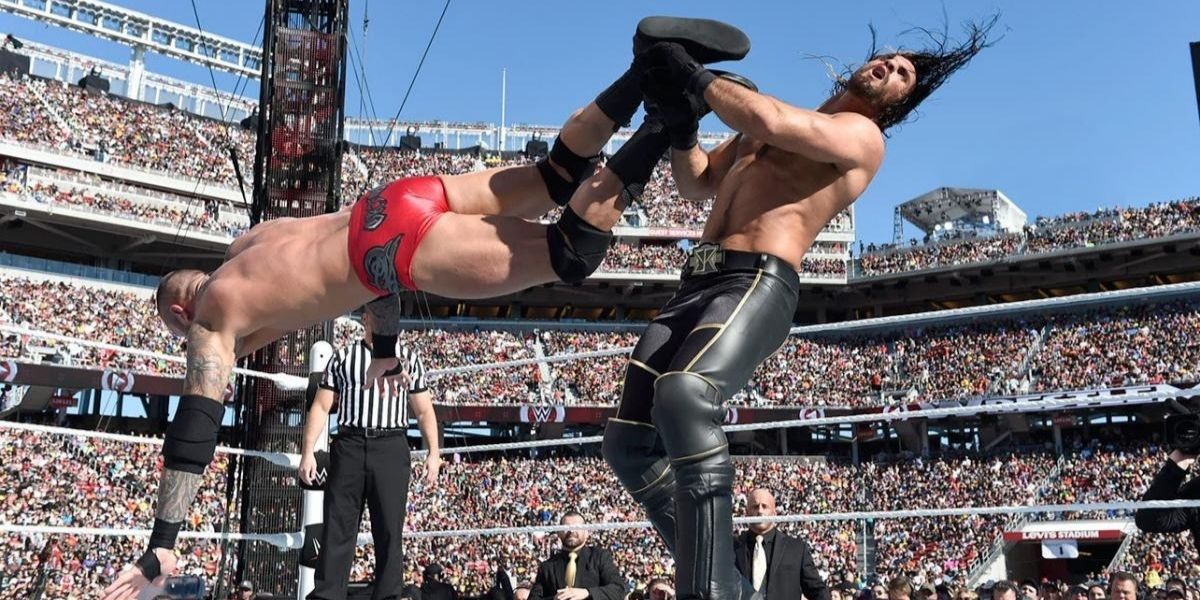 Randy Orton dropkicks Seth Rollins
