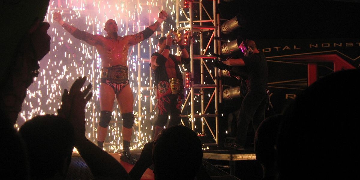 A photo of Tomko and AJ Styles posing on the stage. 