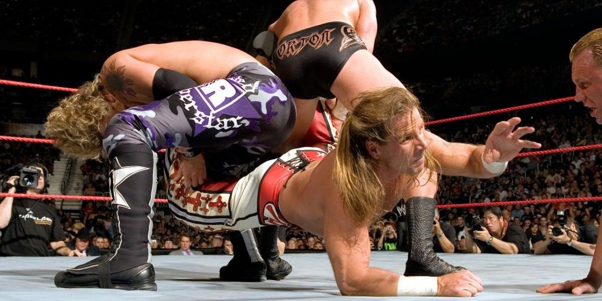 Orton and Edge work a double submission move on Shawn Michaels