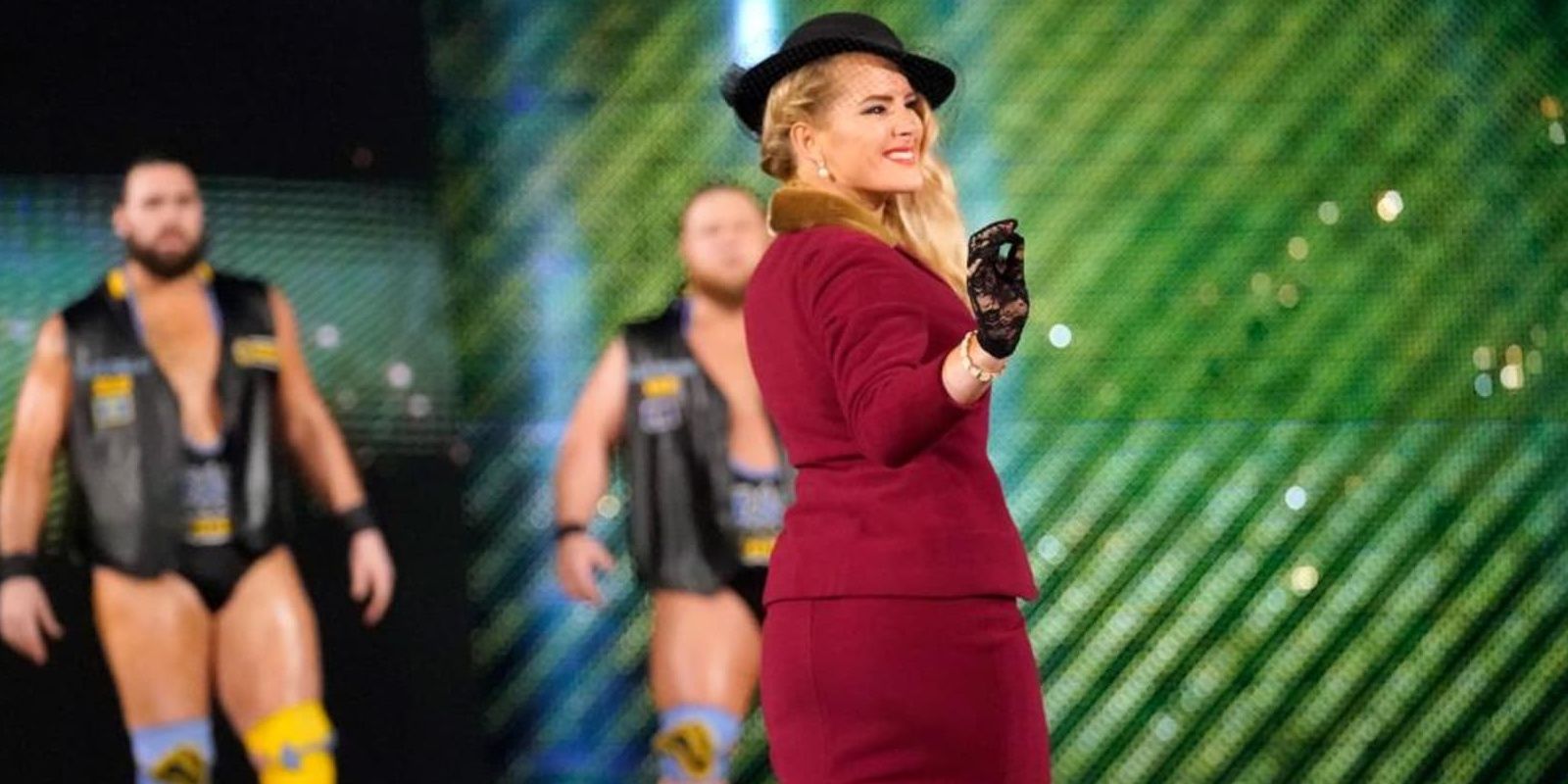 Lacey Evans making her entrance as Heavy Machinery looks on from the back