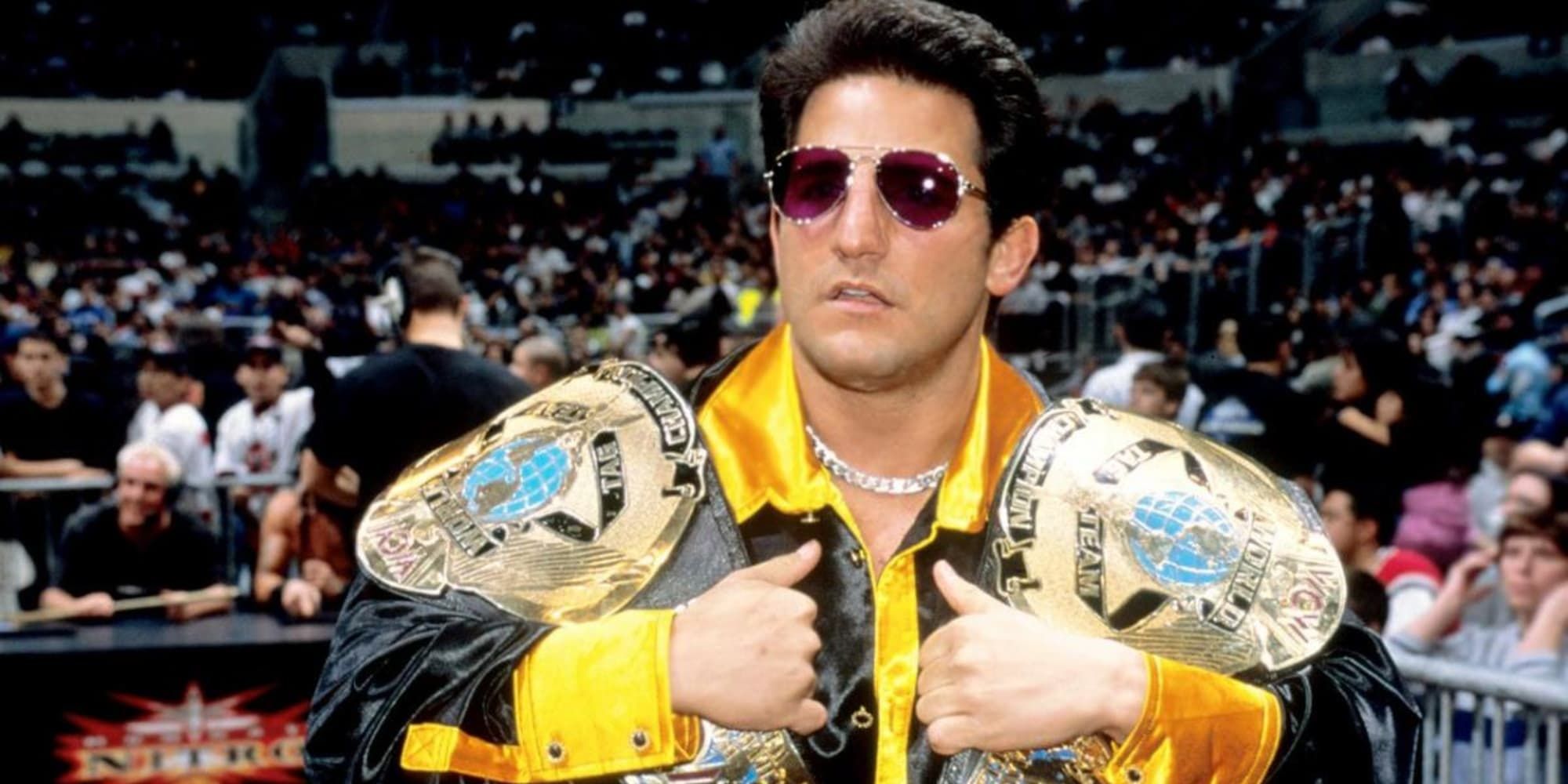 WCW Disco Inferno Holding Two Championship Title Belts At Ringside