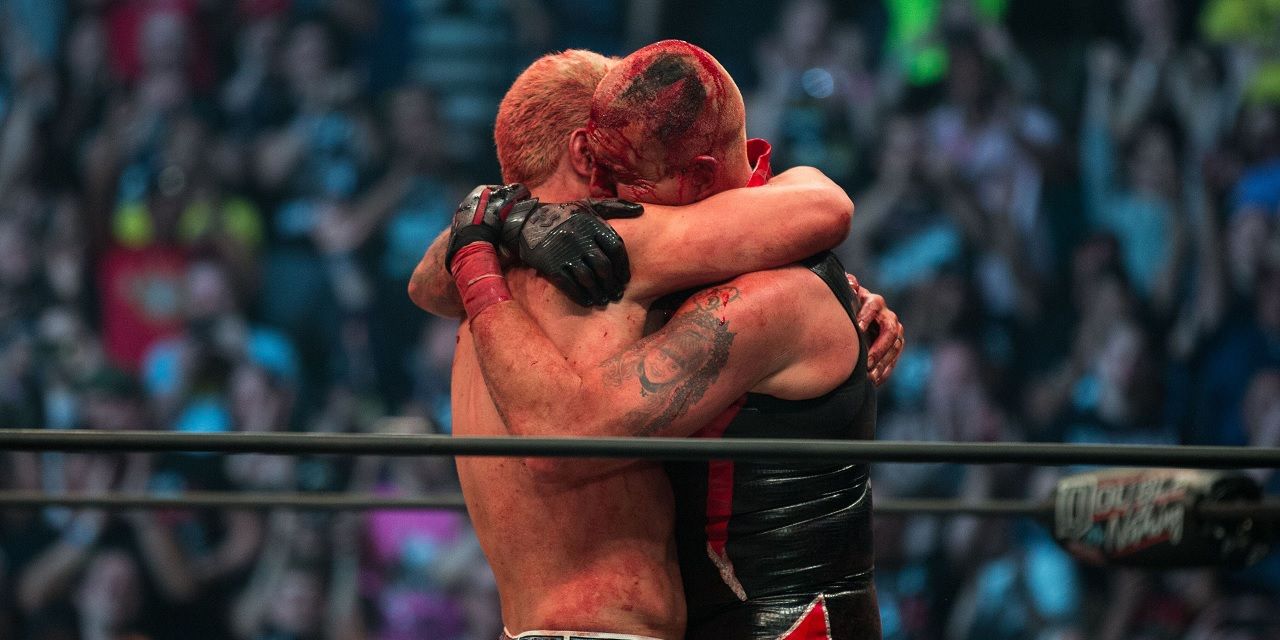 Cody Rhodes and Dustin Rhodes embrace after match in AEW