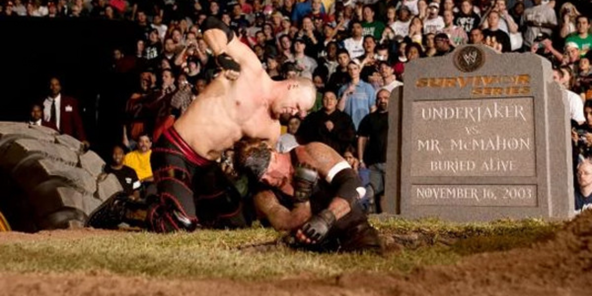 Kane beats up Undertaker in a grave