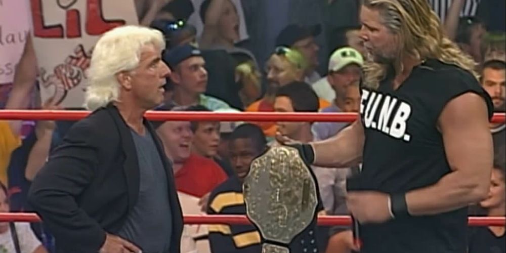 Kevin Nash handing Ric Flair the WCW Championship.