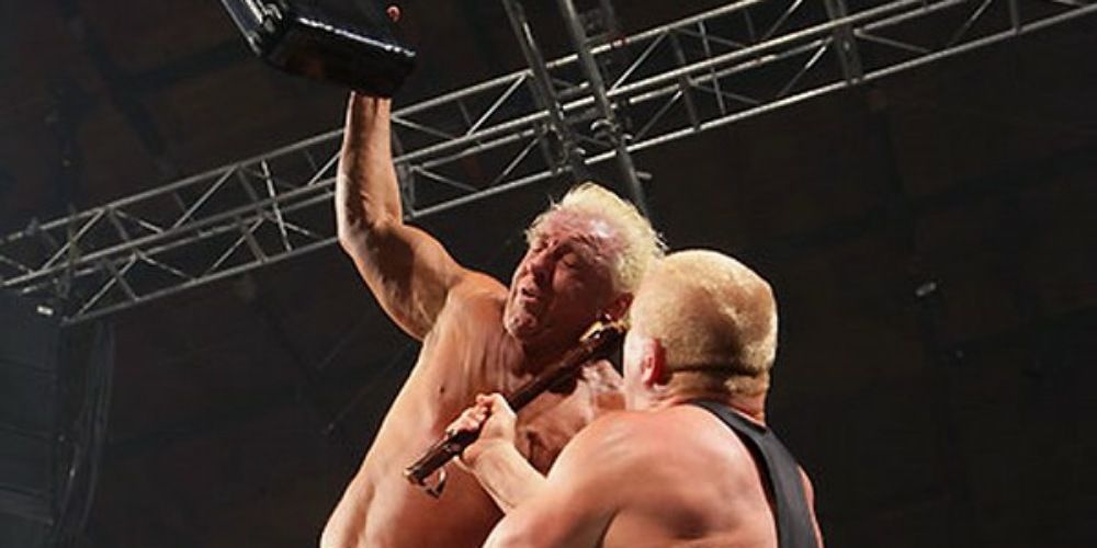 Ric Flair and Finlay fighting atop a ladder.