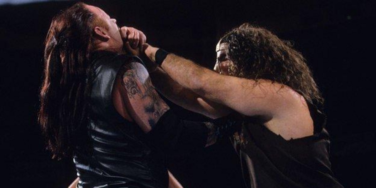 Mankind puts the Mandible Claw on Undertaker