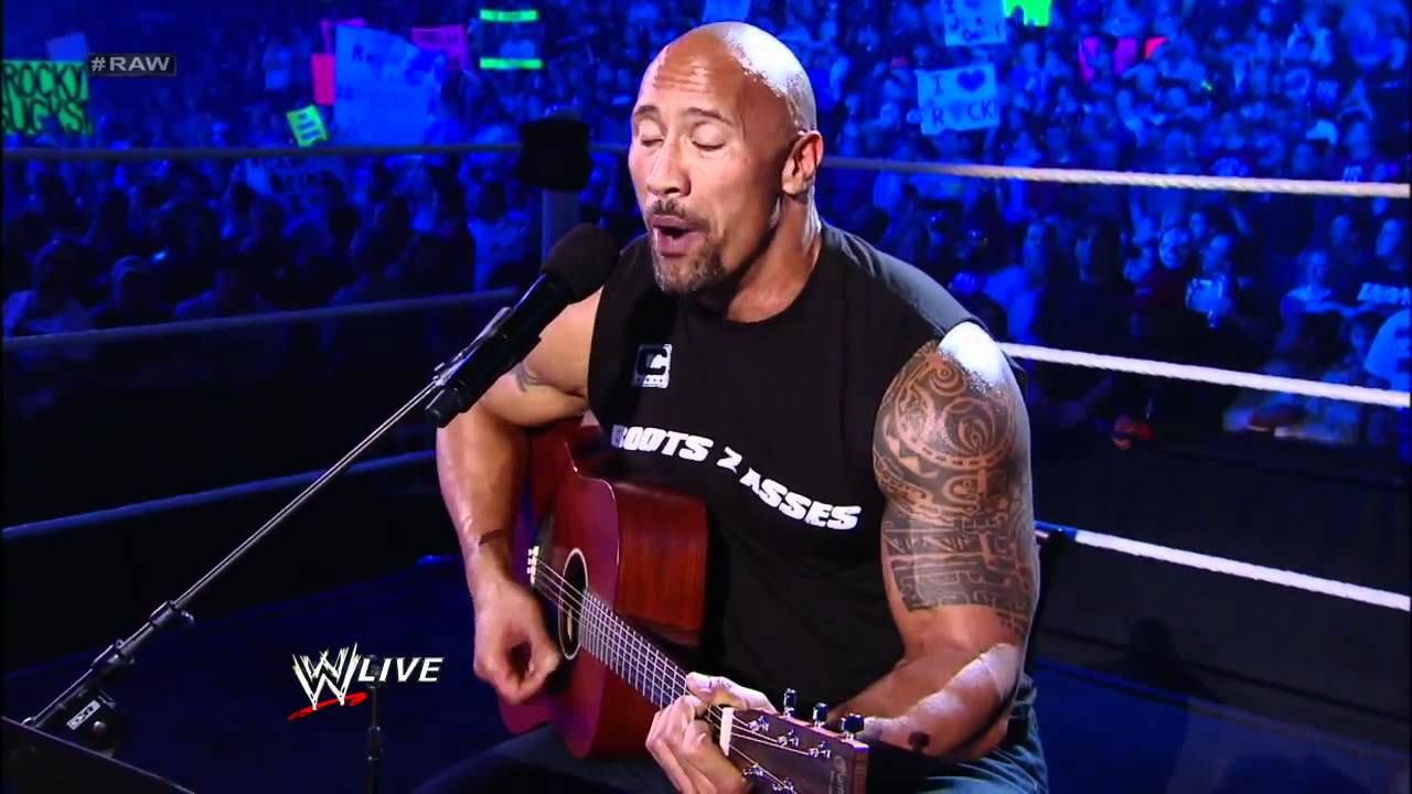 The Rock playing guitar