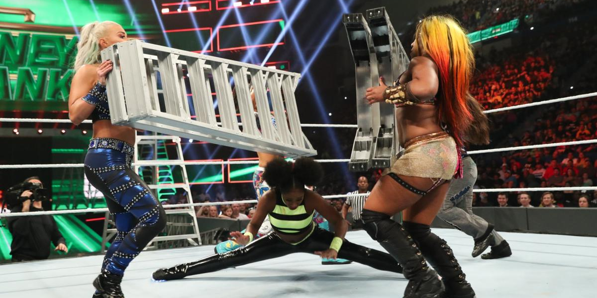 Naomi does a split to avoid being hit by ladders