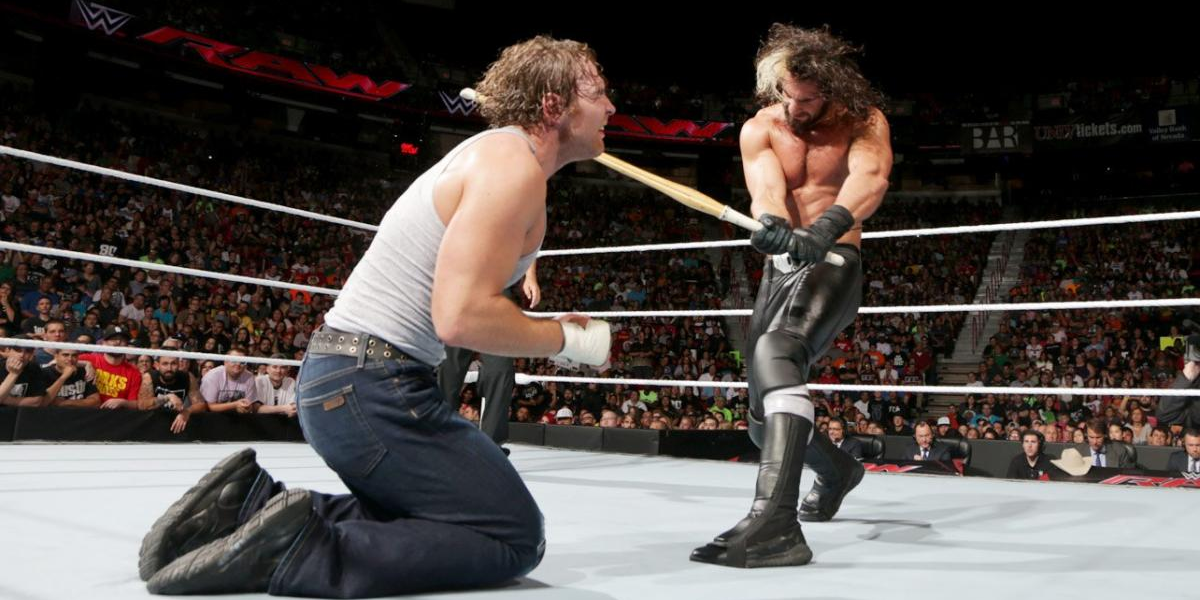 Seth Rollins hits Dean Ambrose with a kendo stick