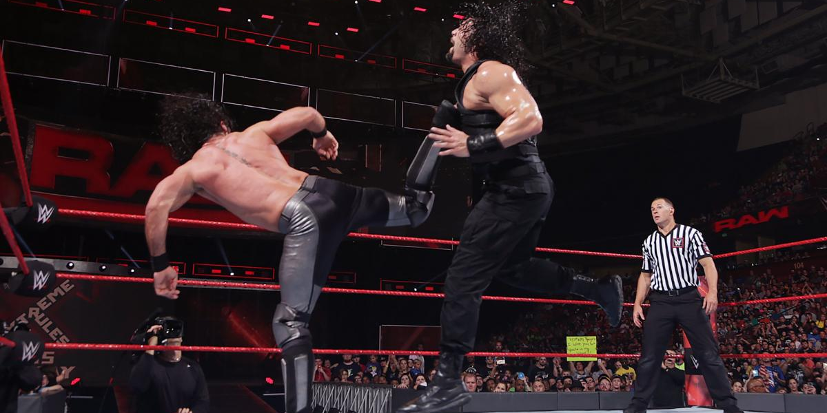 Seth Rollins kicks Roman Reigns