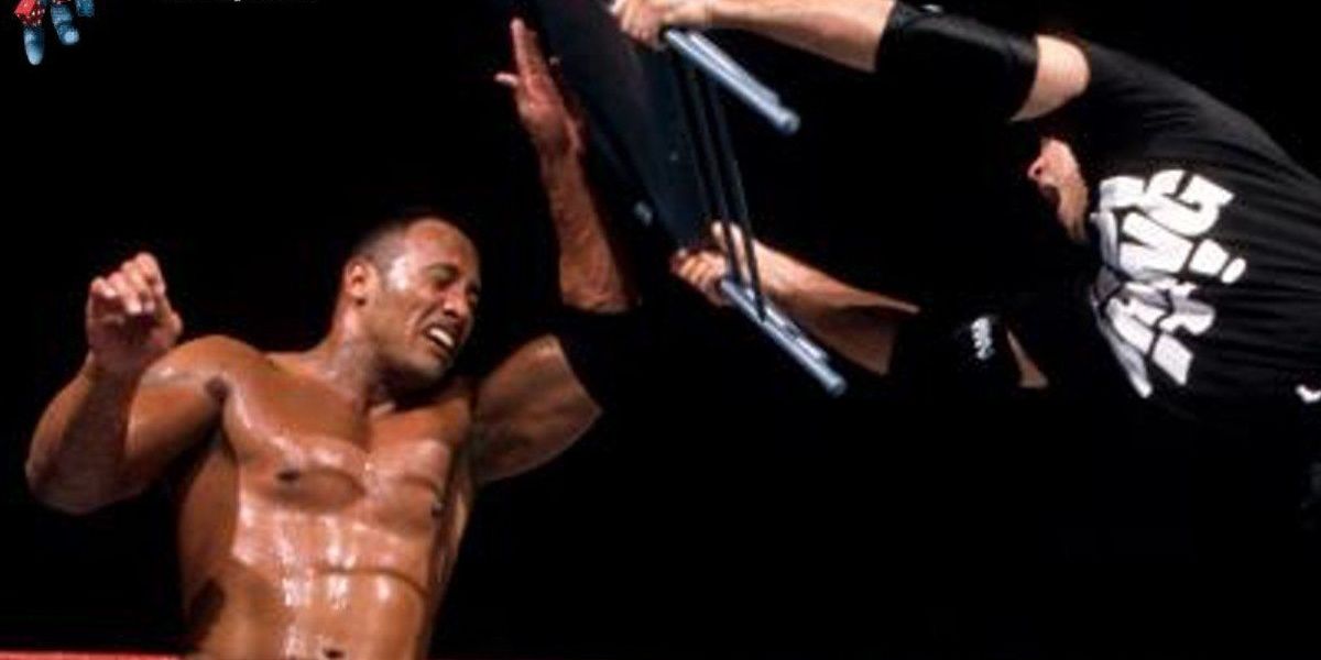 Shane McMahon attacking The Rock with a chair