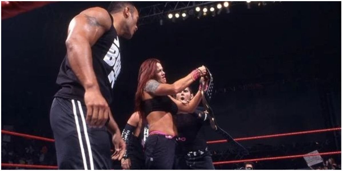 WWE Lita Holding The Women's Championship Beside The Rock And The Hardy Boys