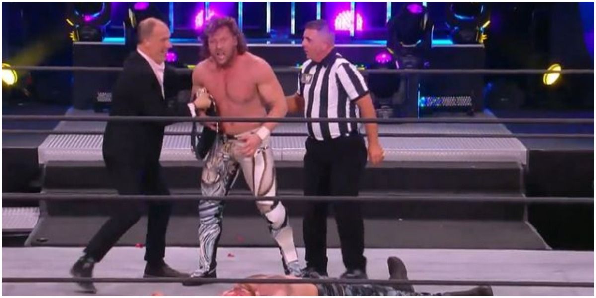 AEW Kenny Omega Holding The World Championship Beside Don Callis Over Jon Moxley