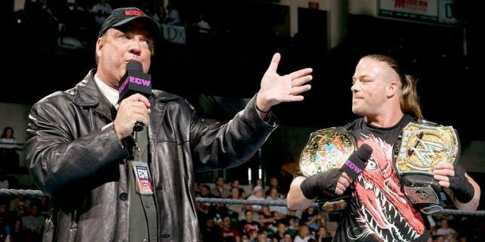 Paul Heyman standing in the ring with ECW and WWE Champion, Rob Van Dam.