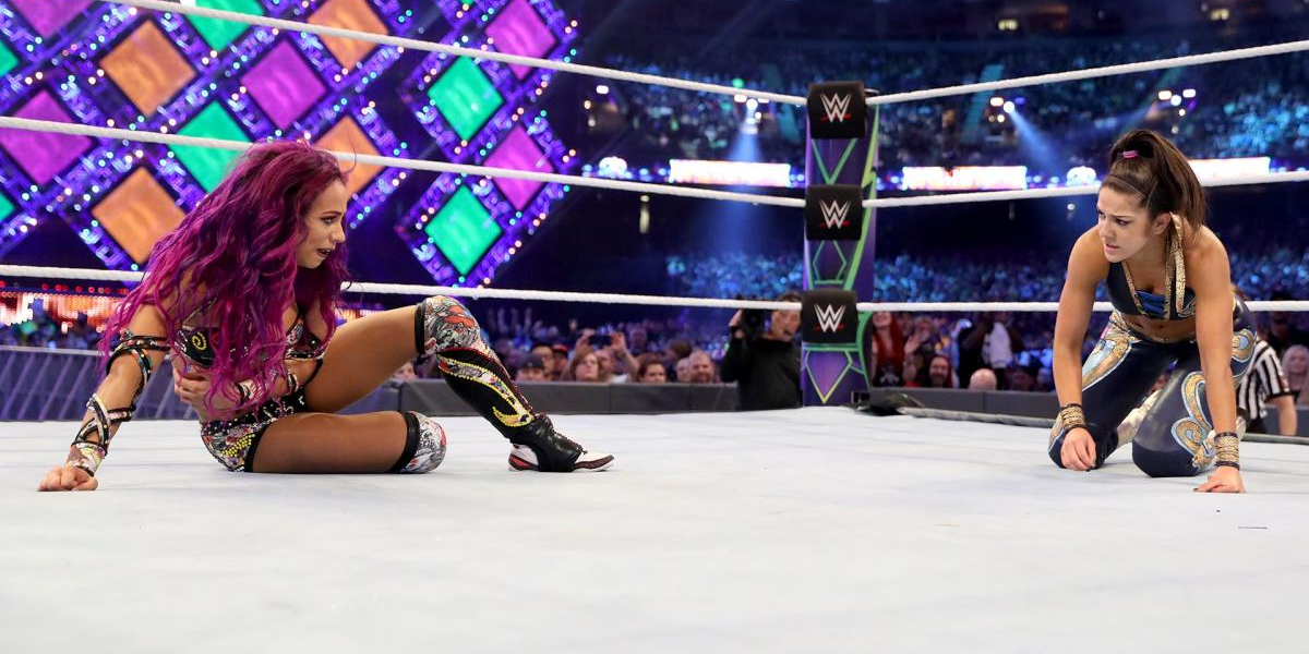 Sasha Banks and Bayley look across the ring at each other at WrestleMania 34