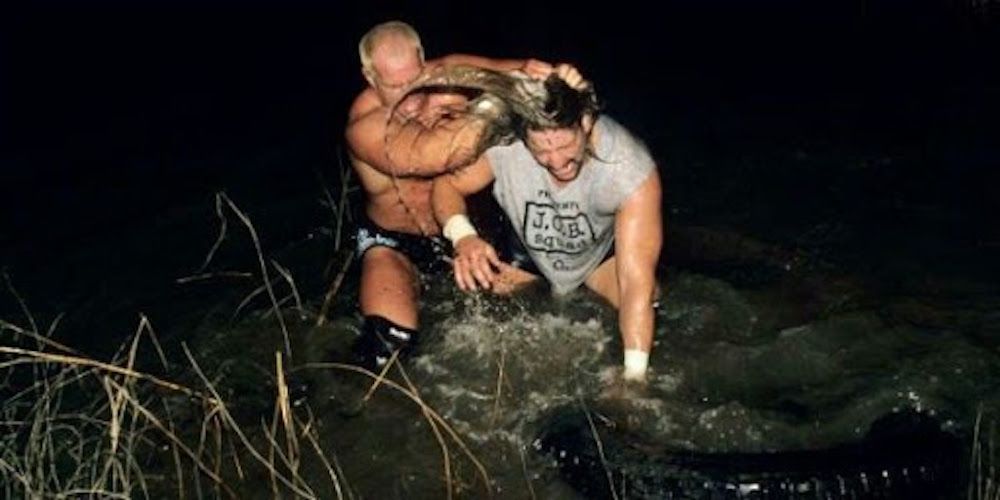 Al Snow and Hardcore Holly fight for the Hardcore Title at the Mississippi River