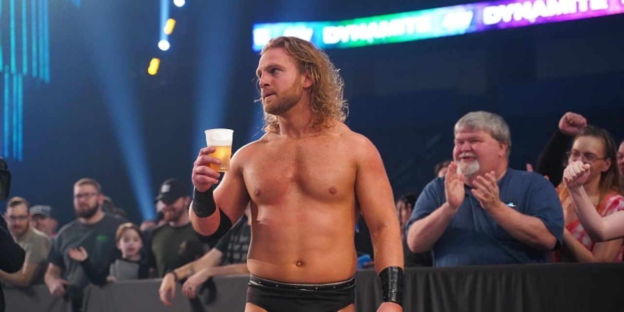 Adam Page holds a beer