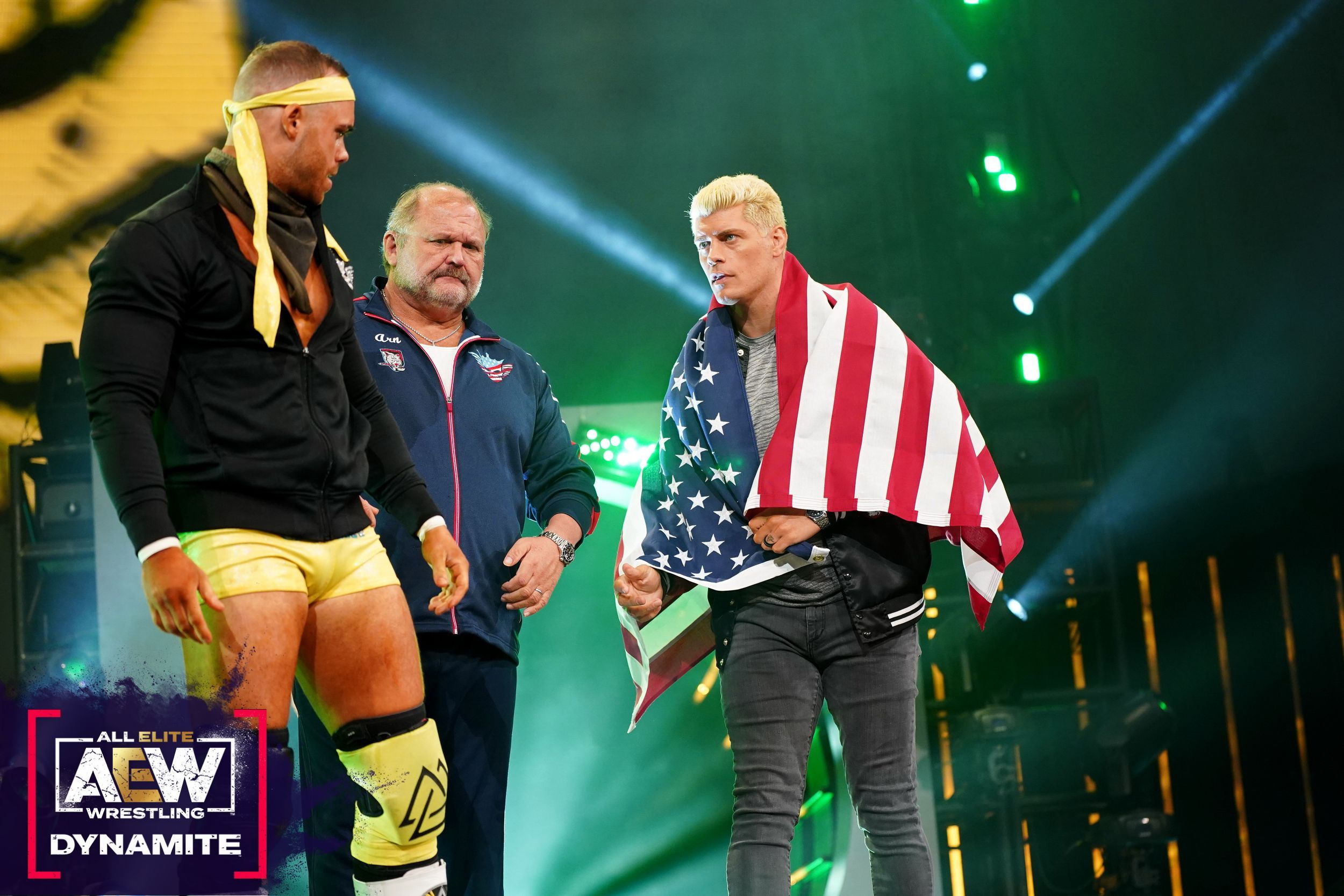 cody rhodes drapes himself in the American flag as he accompanies Austin Gunn to the ring alongside Arn Anderson on Dynamite