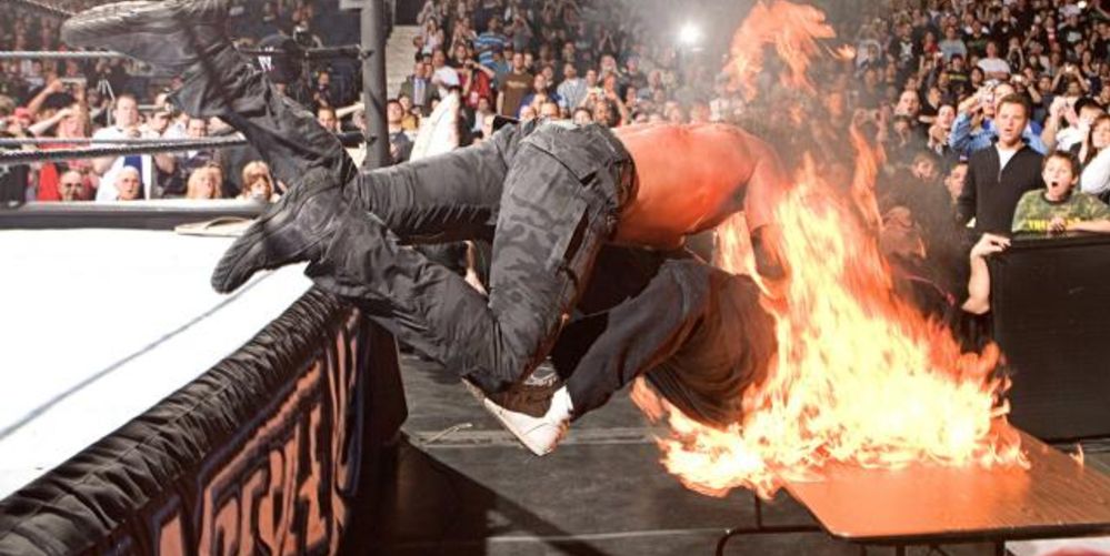 Edge spears Mick Foley through a flaming table - WrestleMania 22