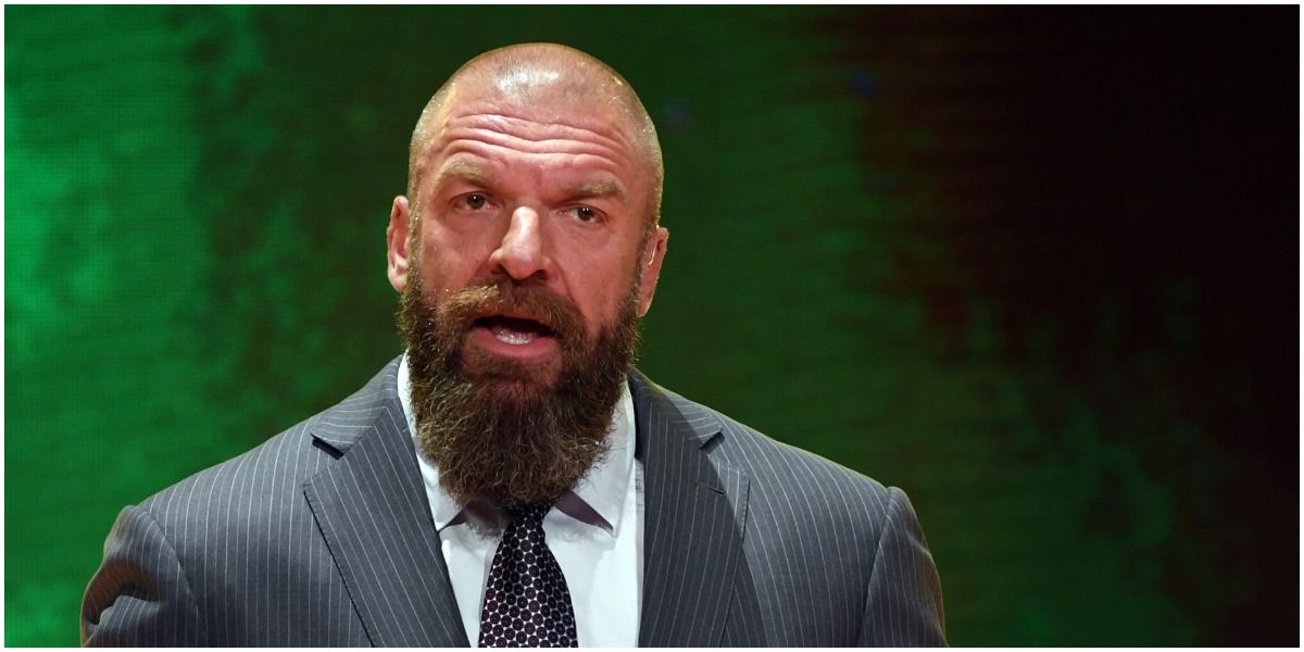 Triple H in a suit cutting a promo