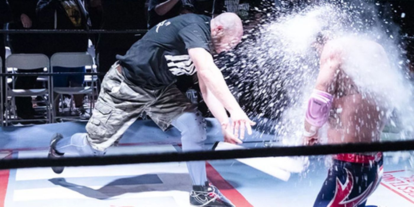 nick gage smashes a lightube over an opponent's head in a deathmatch