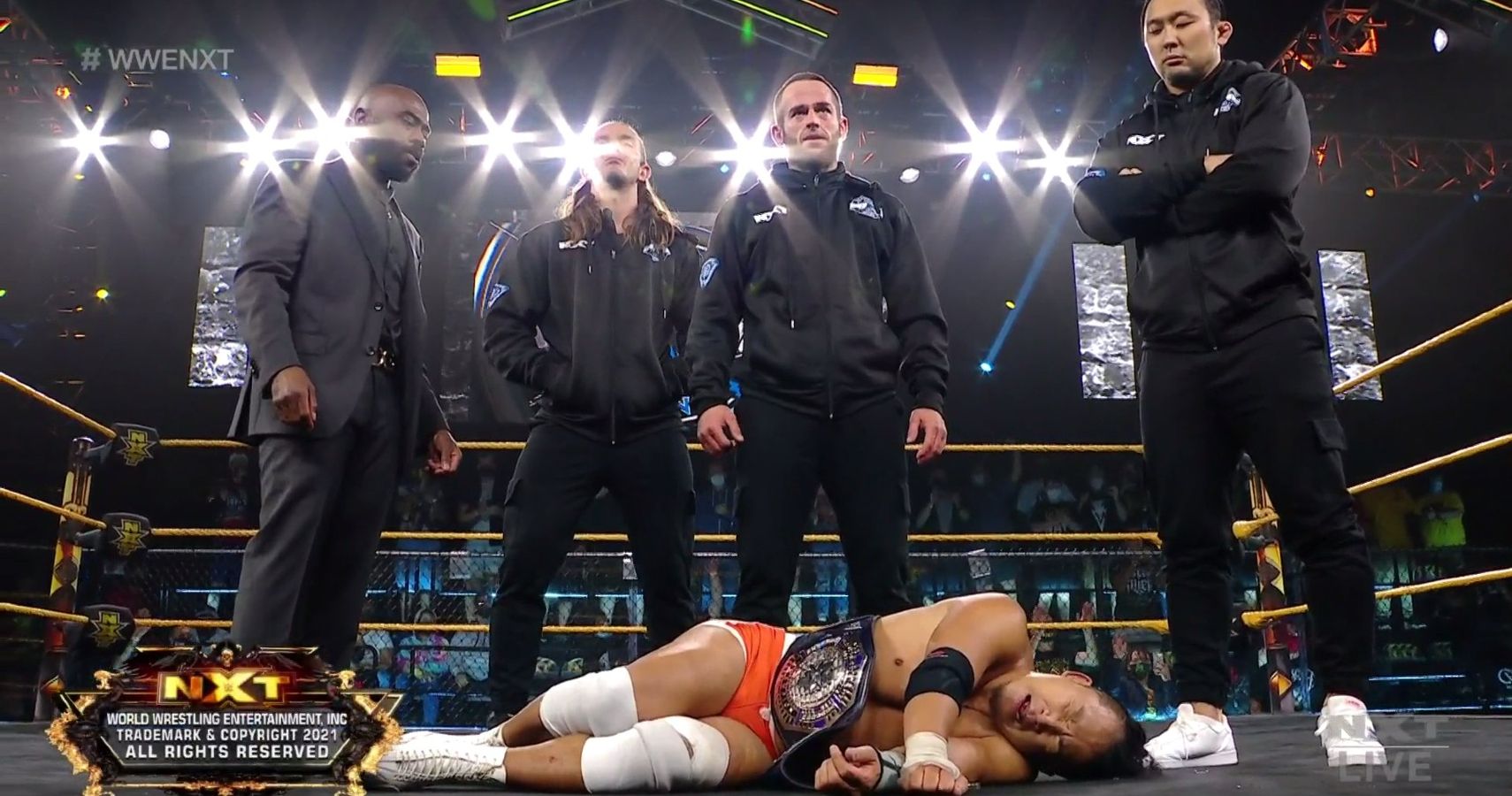 The Diamond Mine (Malcolm Bivens, Tyler Rust, Roderick Strong, and Hideki Suzuki) stand over Kushida after their NXT debut