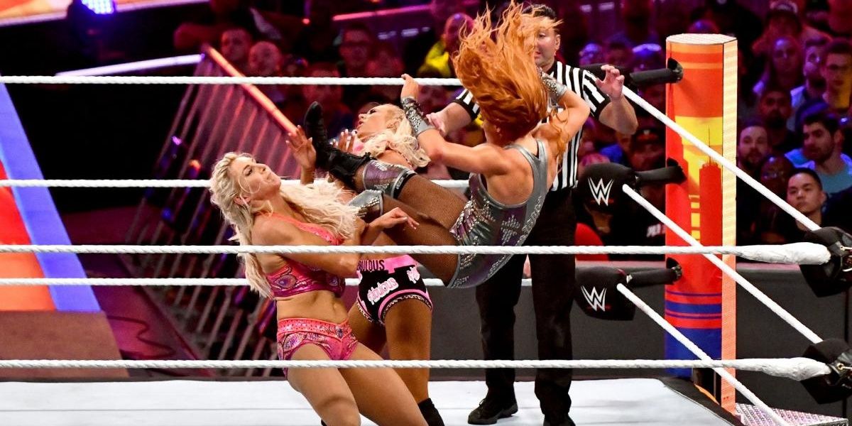 Becky Lynch dropkicks Charlotte Flair and Carmella at SummerSlam 2018 