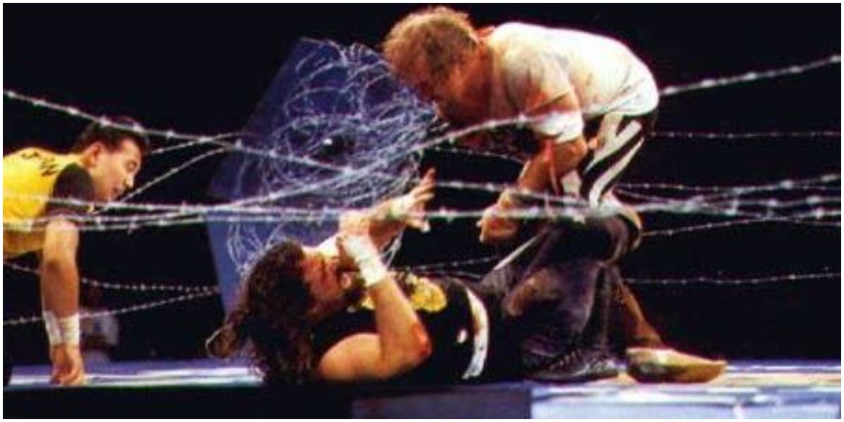 Cactus Jack and Terry Funk wrestling with barbed wire