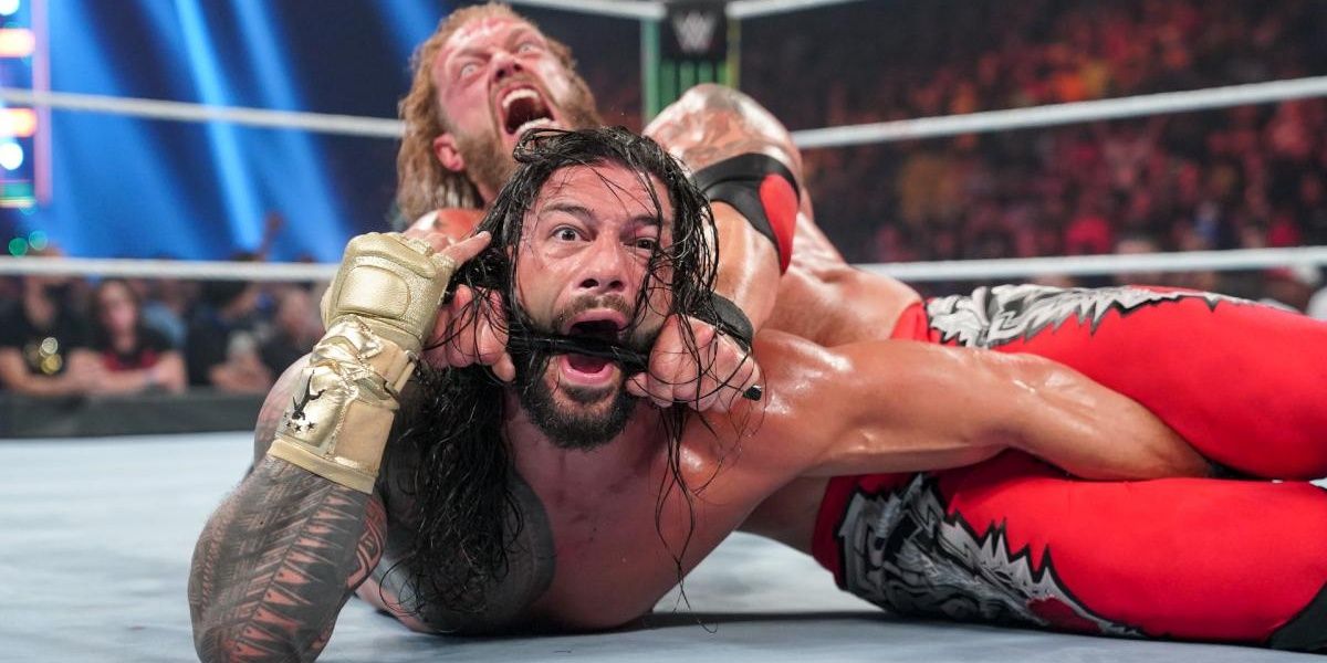 Edge uses the steel chair to choke Roman Reigns at Money in the Bank 