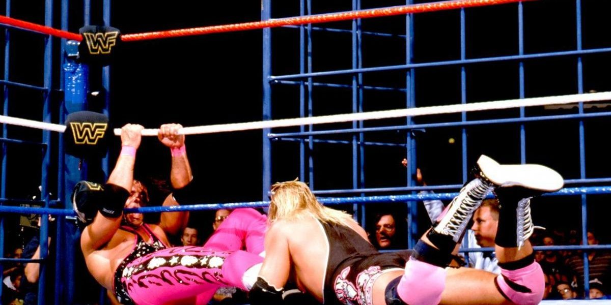 Bret Hart facing Owen Hart inside the steel cage at SummerSlam