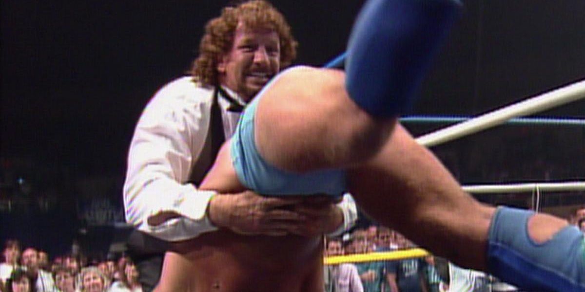 Terry Funk piledrives Ric Flair onto a table in 1989.