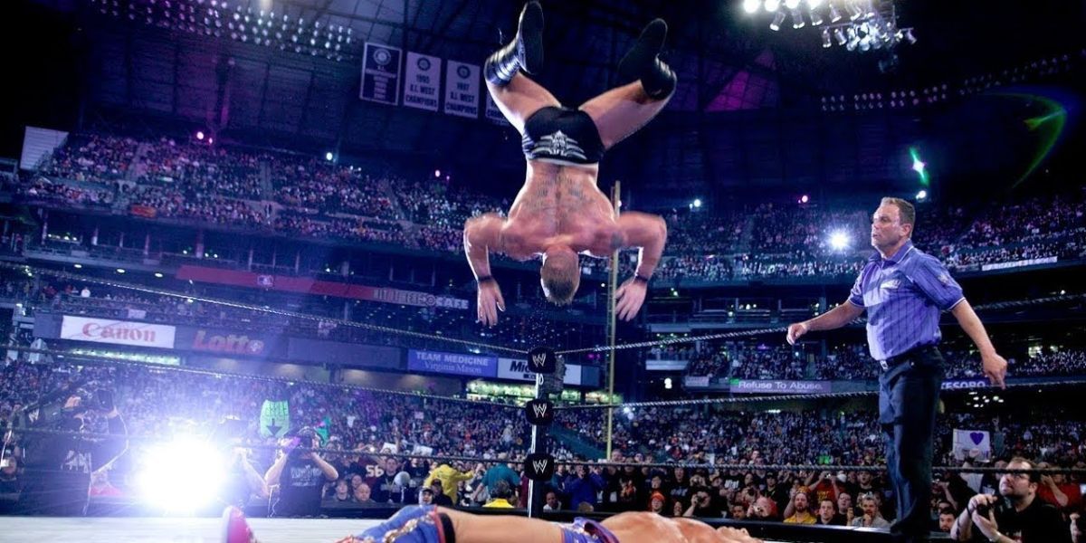 Brock Lesnar performing the Shooting Star Press on Kurt Angle
