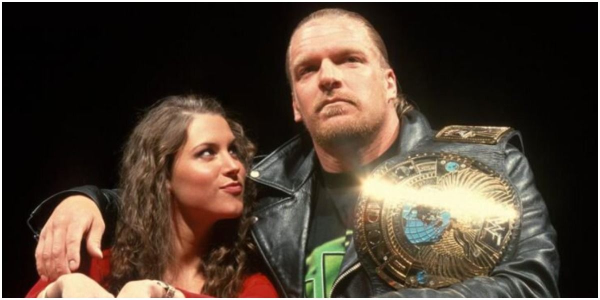 Triple H with belt and Stephanie McMahon in ring 