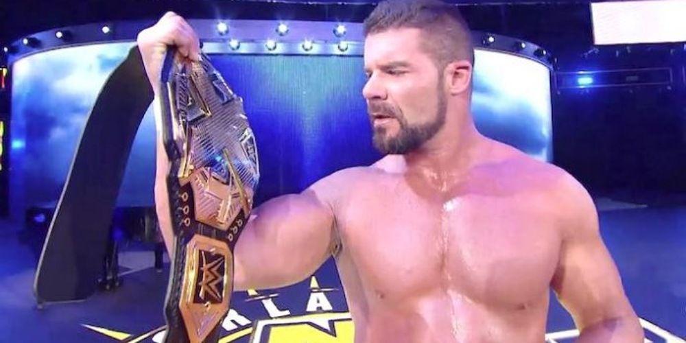 Bobby Roode holding the NXT Championship. 