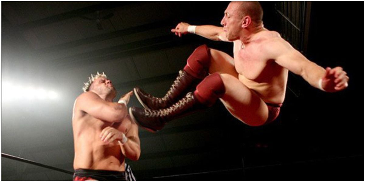 Bryan Danielson delivering a dropkick to Nigel McGuinness