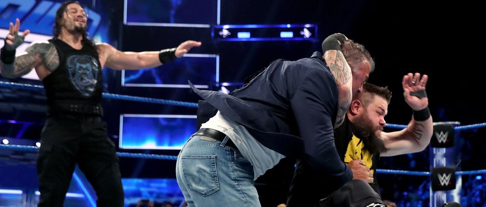 Roman Reigns watches Kevin Owens hit a stunner on Shane McMahon