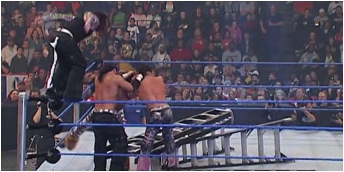 Jeff Hardy jumping onto ladder while Matt Hardy holds MNM over ladder