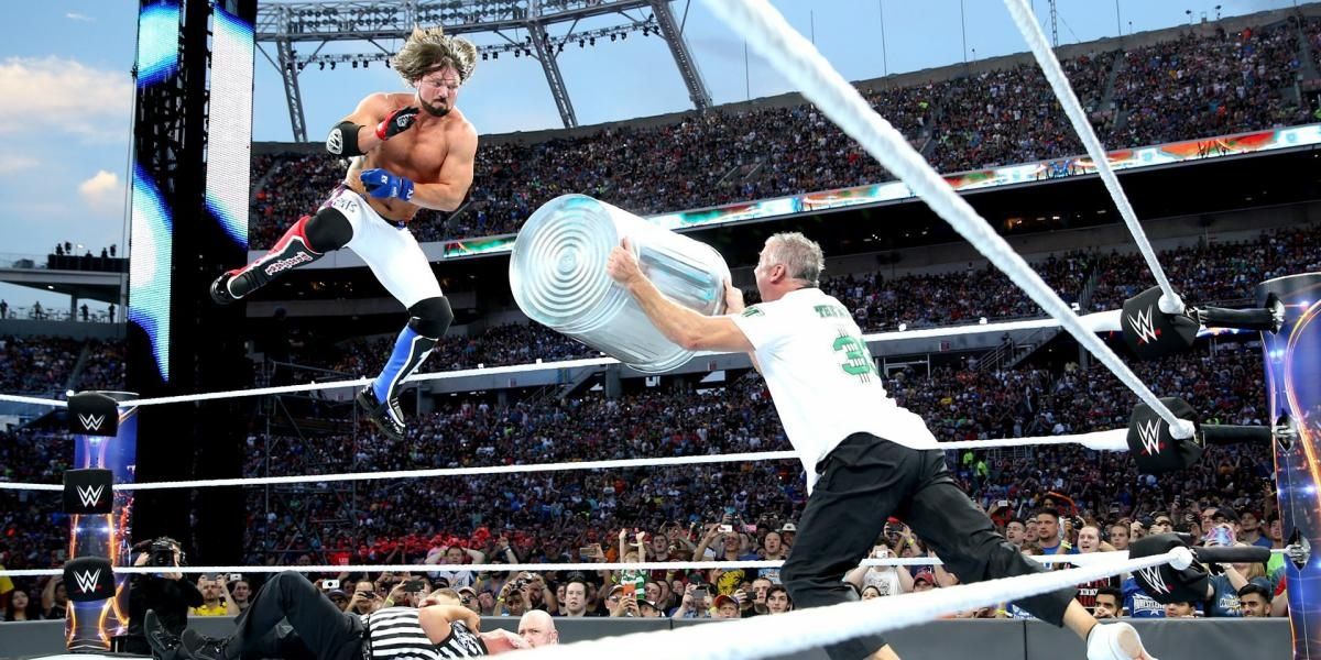 AJ Styles flying into a trash can shot