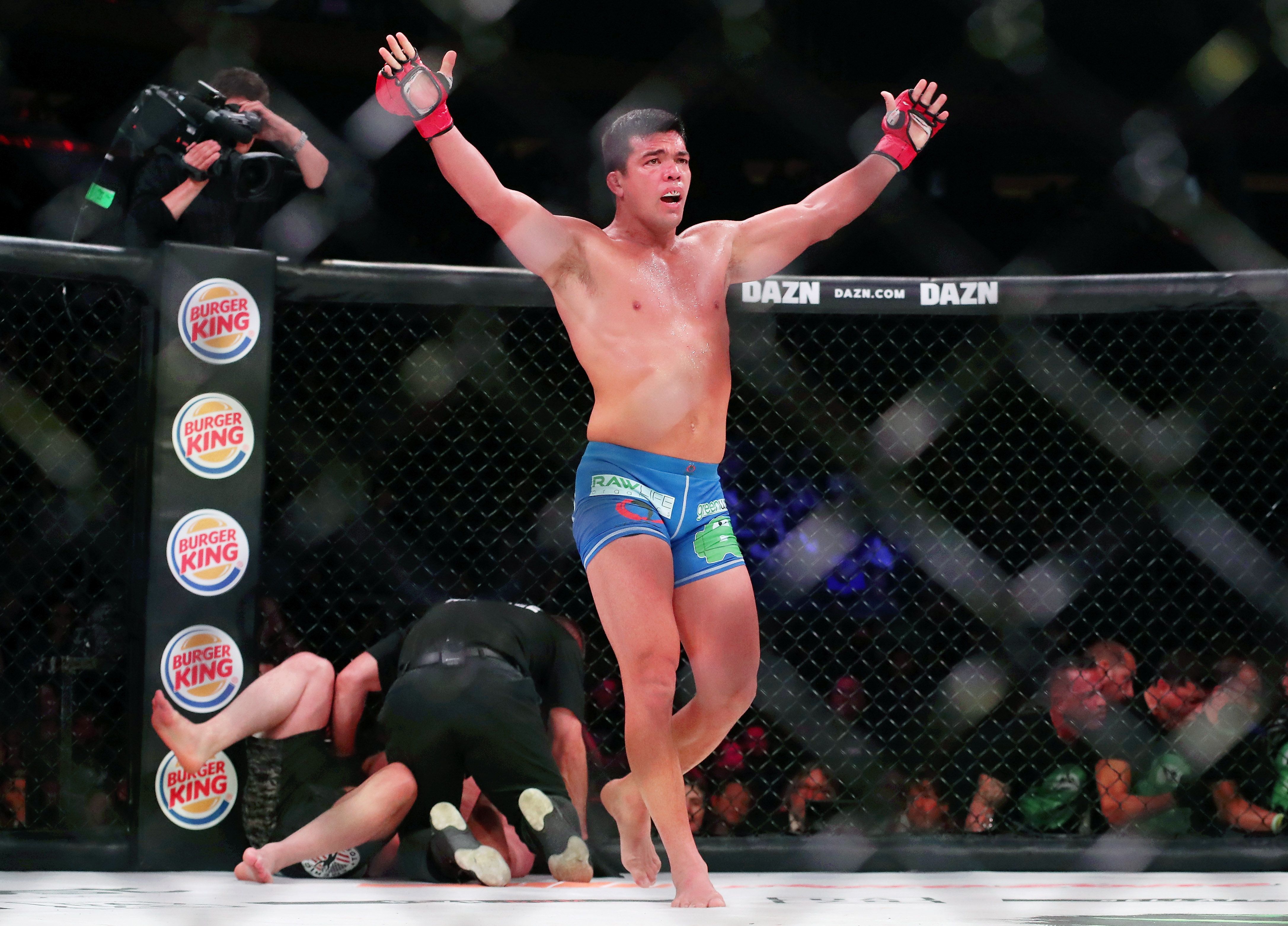 Lyoto Machida (red gloves) celebrates after his win over Chael Sonnen (blue gloves) during Bellator 222
