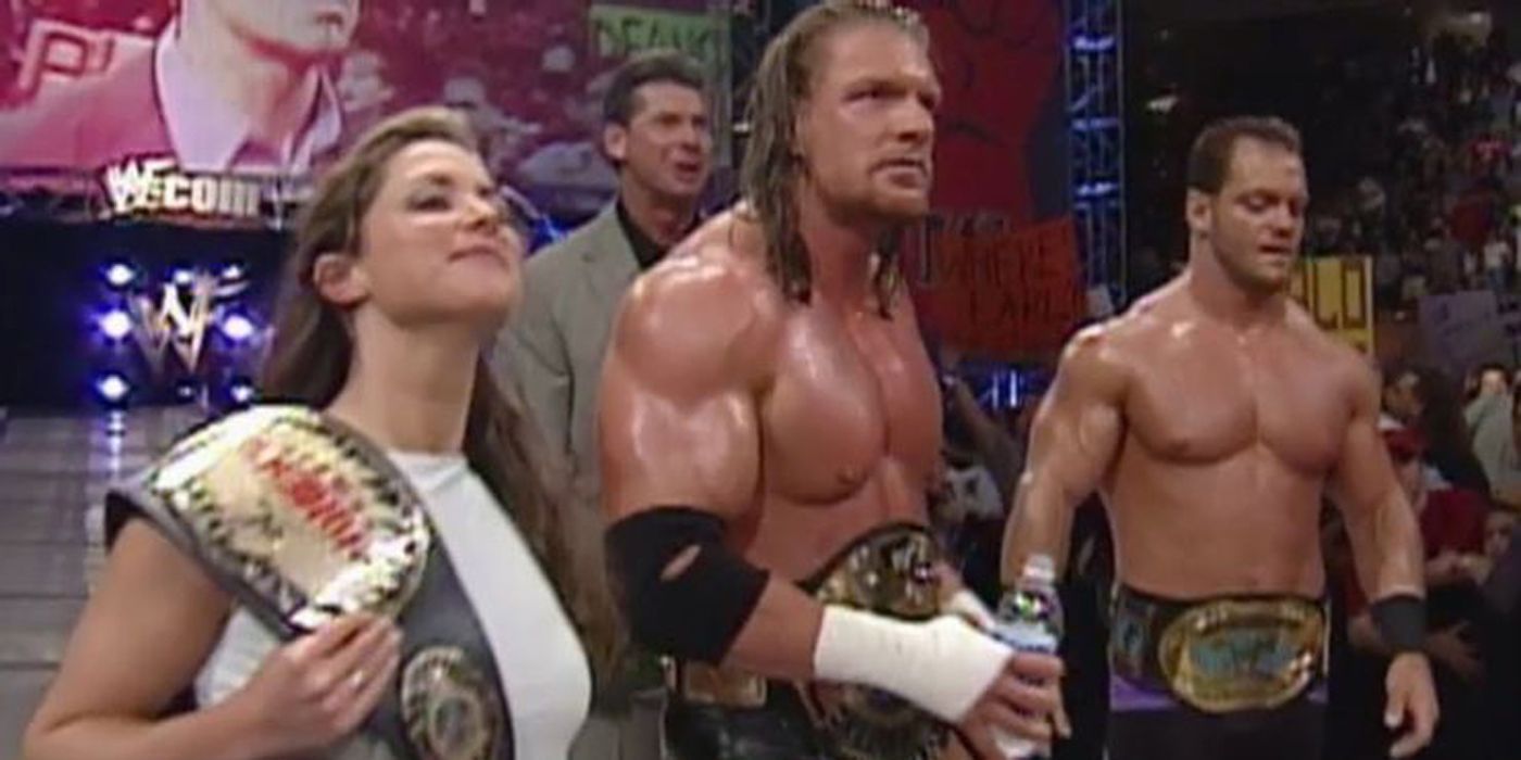 The McMahon-Helmsley alliance standing at ringside with Chris Benoit