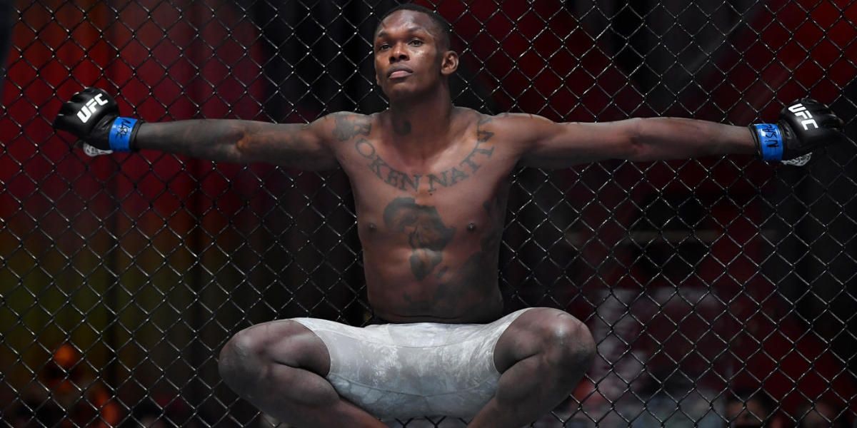 Israel Adesanya takes a personal moment before his fight.