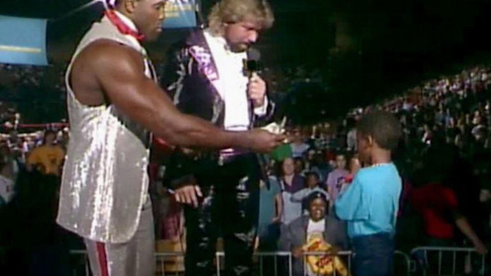 Ted DiBiase and Virgil pay a child to dribble a basketball