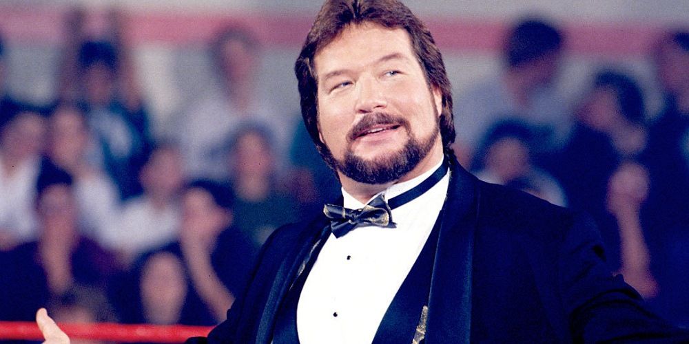 Ted DiBiase smiling in the ring.